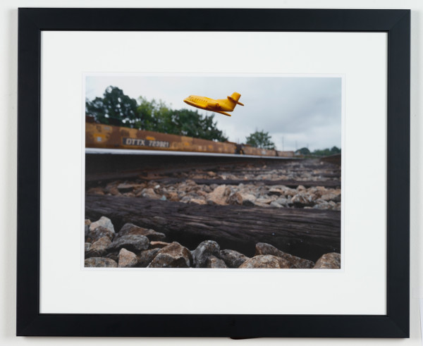 Approximate Altitude ? Inches, Inches Above Earth Series (Yellow Jet Over Railroad Track) by Michael Reese
