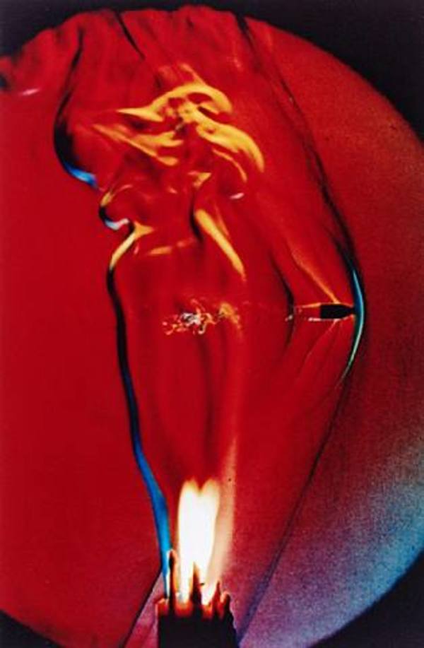 Bullet through candle flame by Harold Edgerton