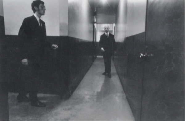 Untitled (men in hall), c. 1975 by Duaine Michals