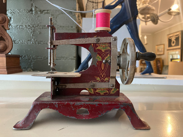 Red vintage toy sewing machine