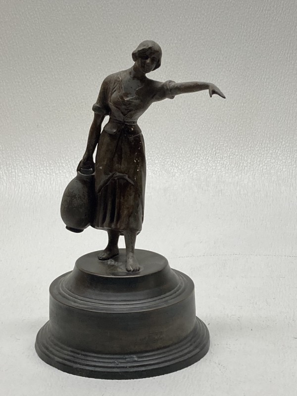 Sculptural woman carrying water