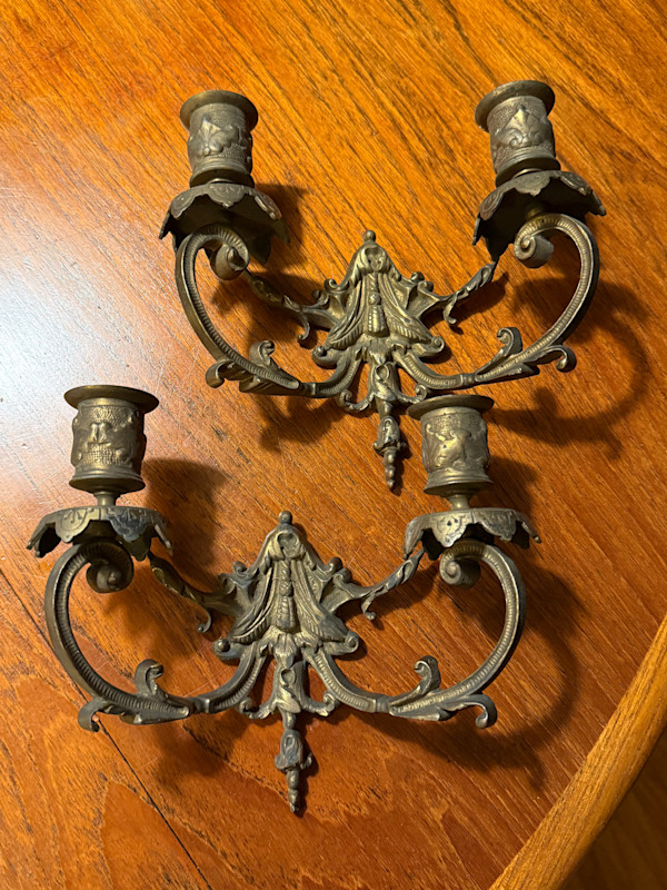Pair of ornate brass wall mounted candelabra