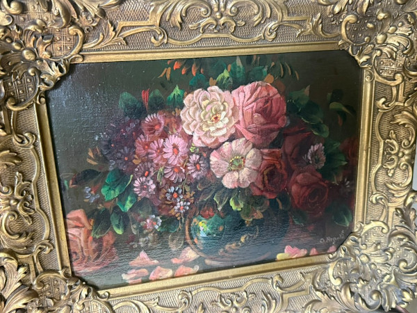 framed floral painting in ornate frame