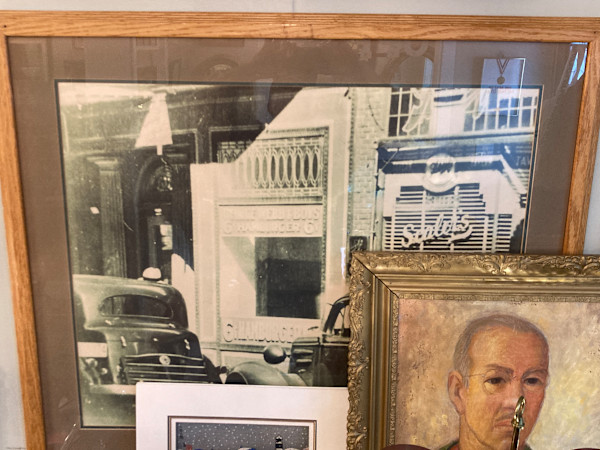 Large framed black and white photo of a street scene and cars