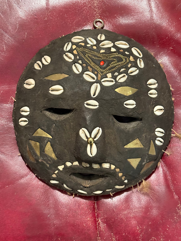 Carved mask with shells