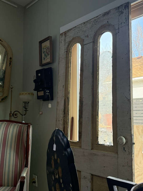 Primitive painted 19th century farm door with arched glass