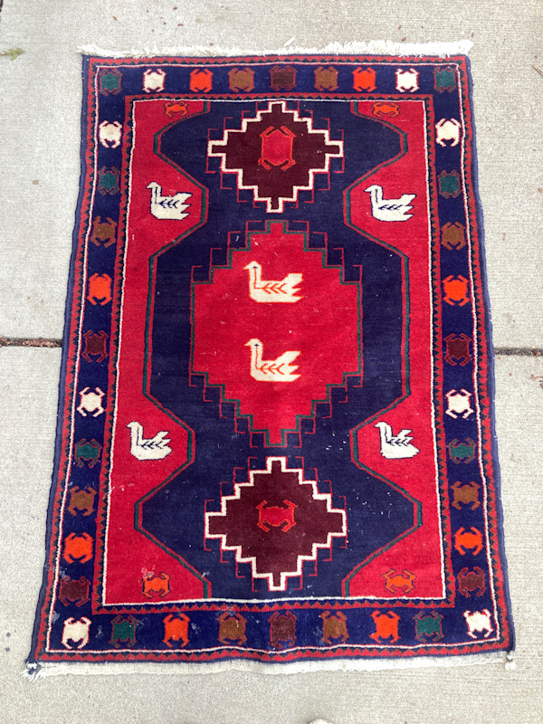 Vintage handmade rug with swans