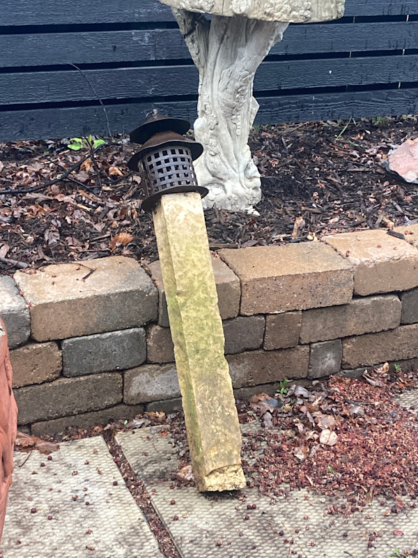 iron Asian lantern with stone post