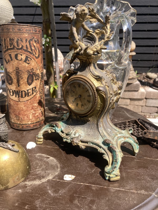Ornate metal clock with cherub