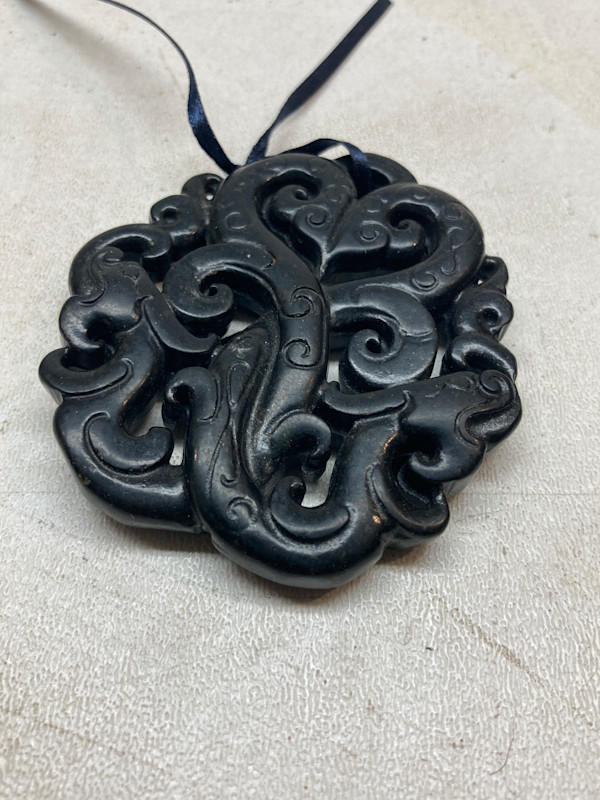 carved double soapstone serpent pendant