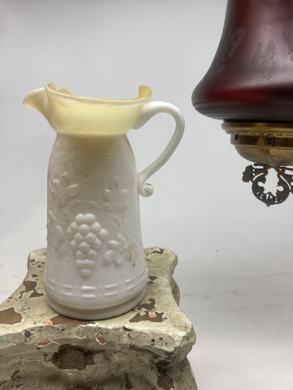 White cased glass pitcher with grape pattern