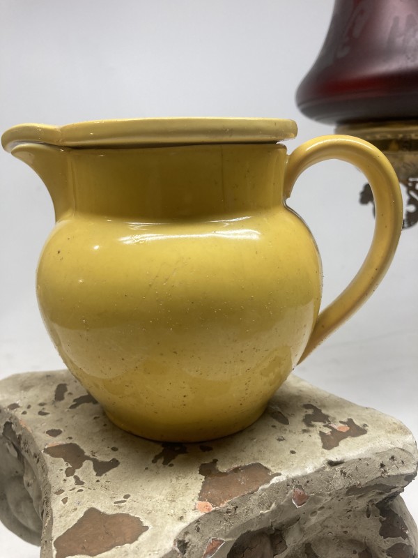 yellow pottery water pitcher with lid