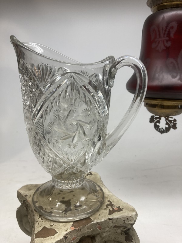 clear glass ornate water pitcher
