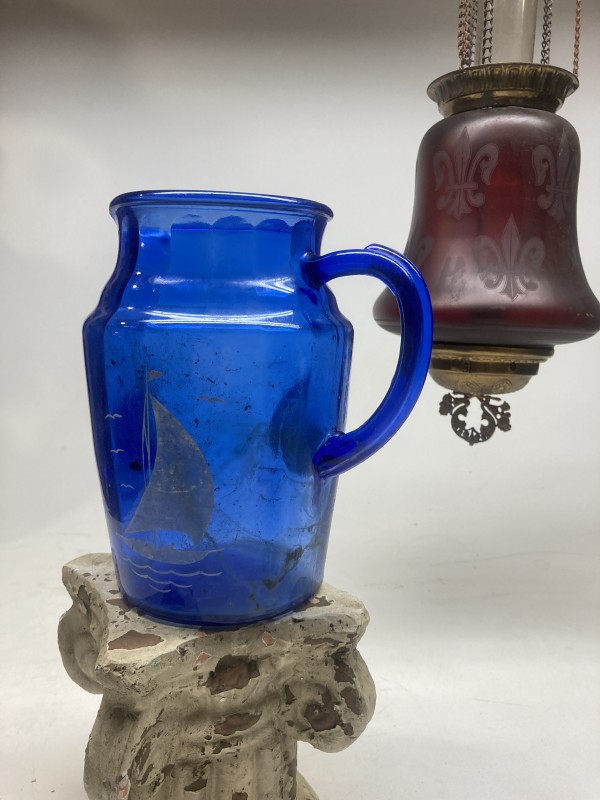 blue glass water pitcher with sail boat