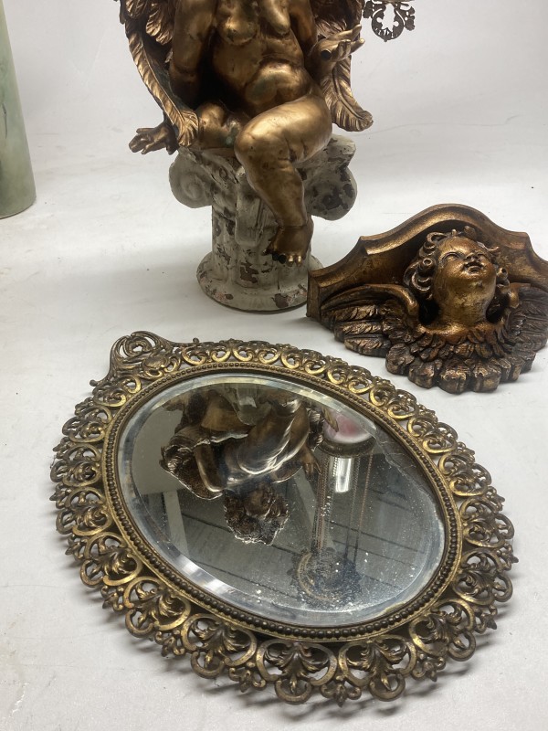 Ornate metal oval mirror
