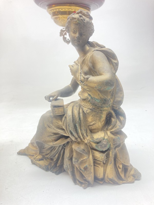 gold colored Victorian figure