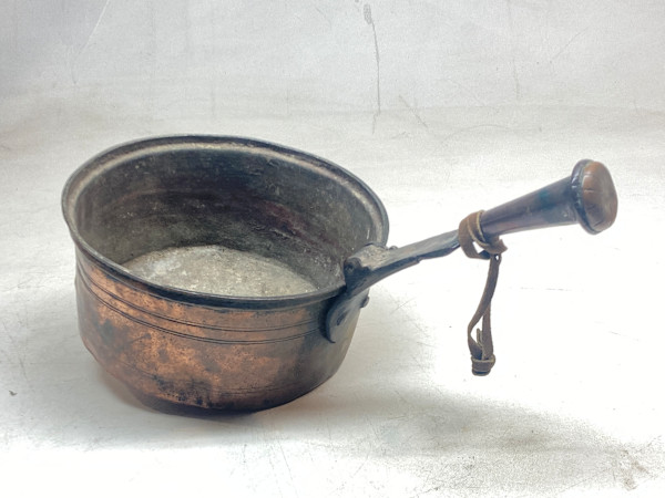medium sized copper sauce pan with interesting handle