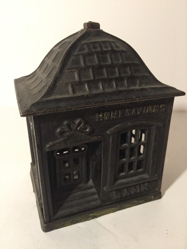 vintage iron penny bank in the shape of a bank