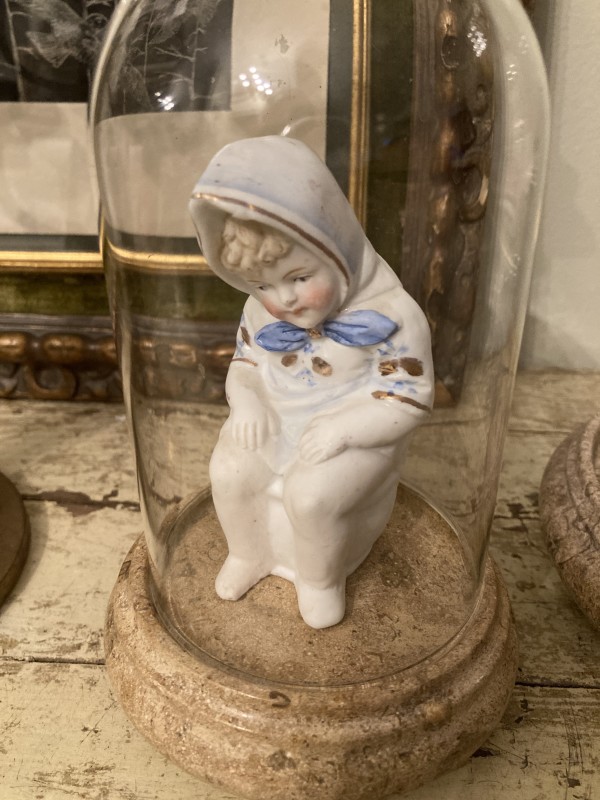 Small bisque figure of child on toilet
