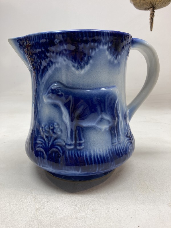 Flow blue pitcher with cow
