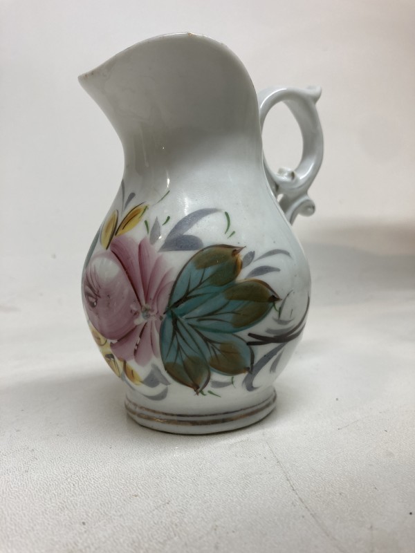 small porcelain pitcher with hand decorated flower