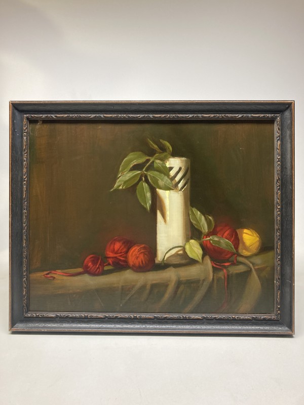 Framed still life with white vase and yarn