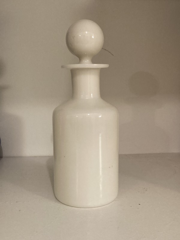 white  milk glass bottle with stopper