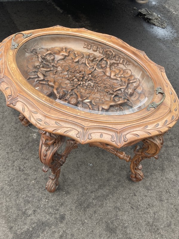 Carved oval table with glass top