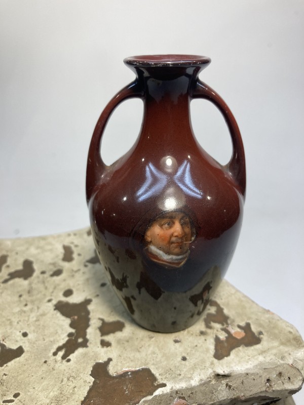 Small two handled pottery vase with portrait