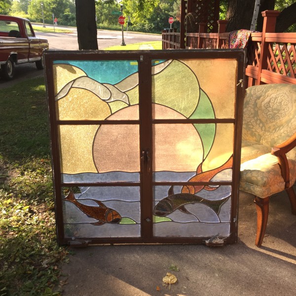 Large stained glass window in shuttered iron frame