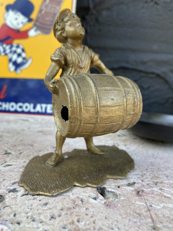 turn of the century boy with barrel metal figure