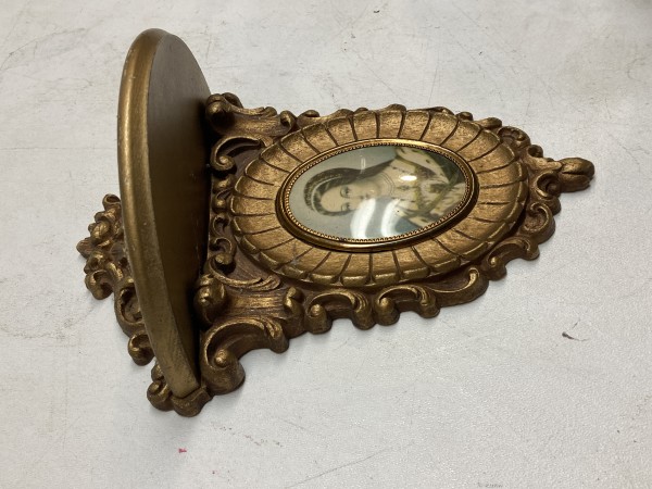 carved gold shelf with oval picture