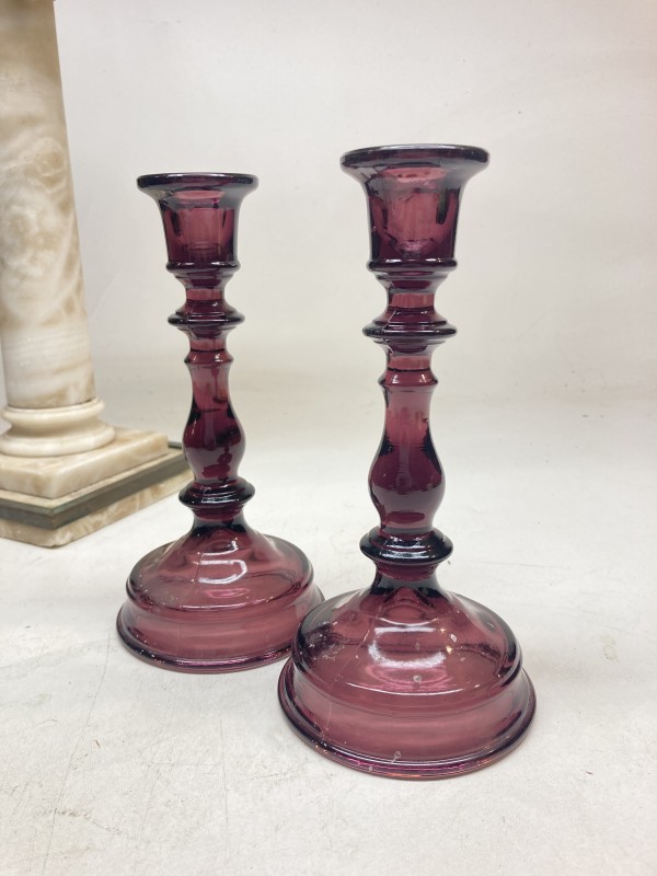 Pair of amethyst glass candle sticks