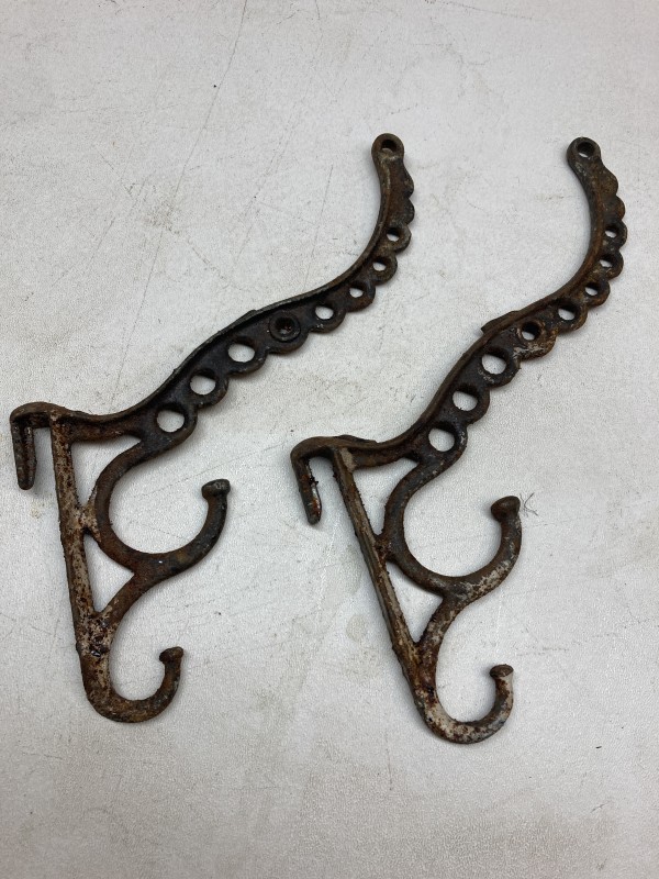 pair of iron turn of the century hooks