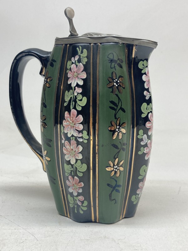 covered enameled pottery pitcher
