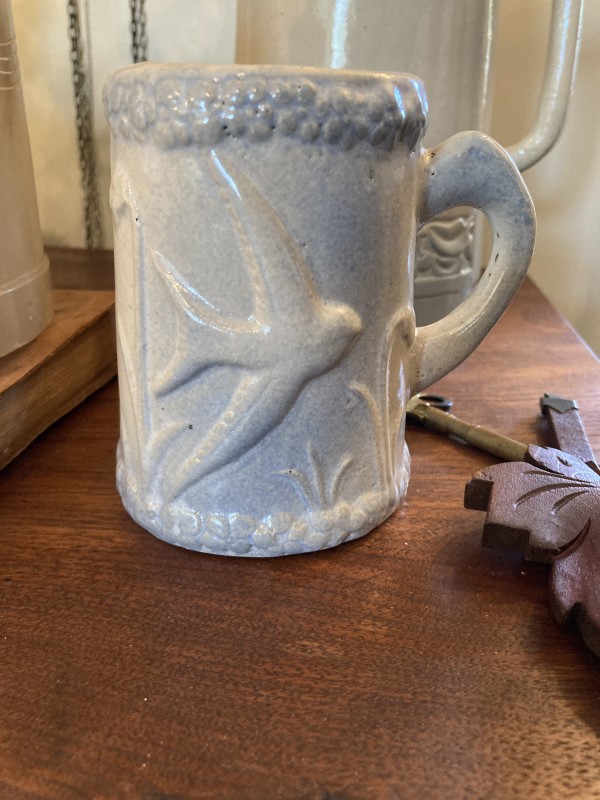 blue and white pottery mug with birds