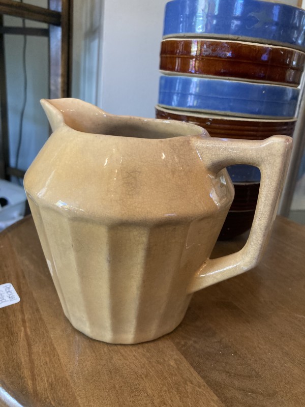 small tan pottery pitcher