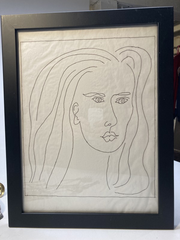 Framed drawing of woman's face
