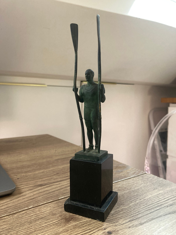 Rowing bronze sculpture on marble base