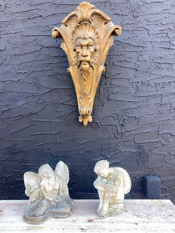 Carved cement figural sculpture