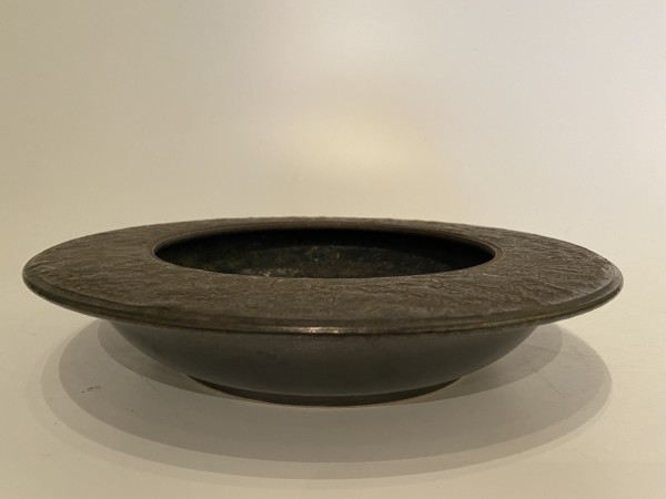 Flat, black ceramic ikebana vase