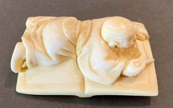 Netsuke - Scholar on a book