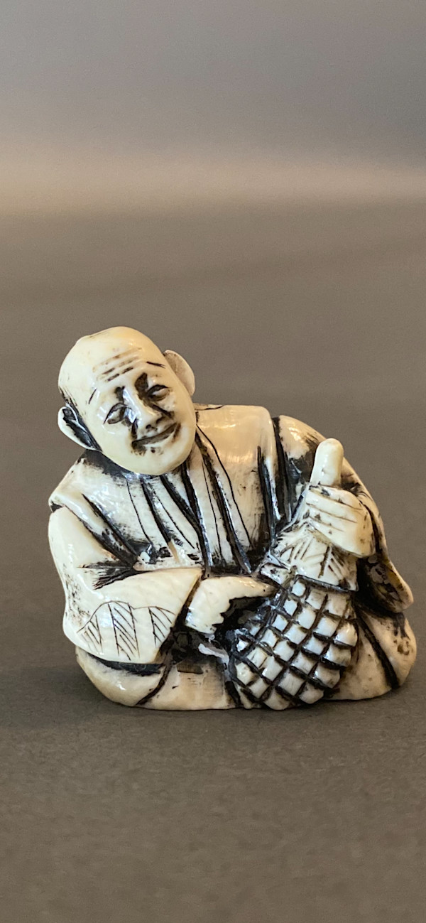 Netsuke - Seated man with flask