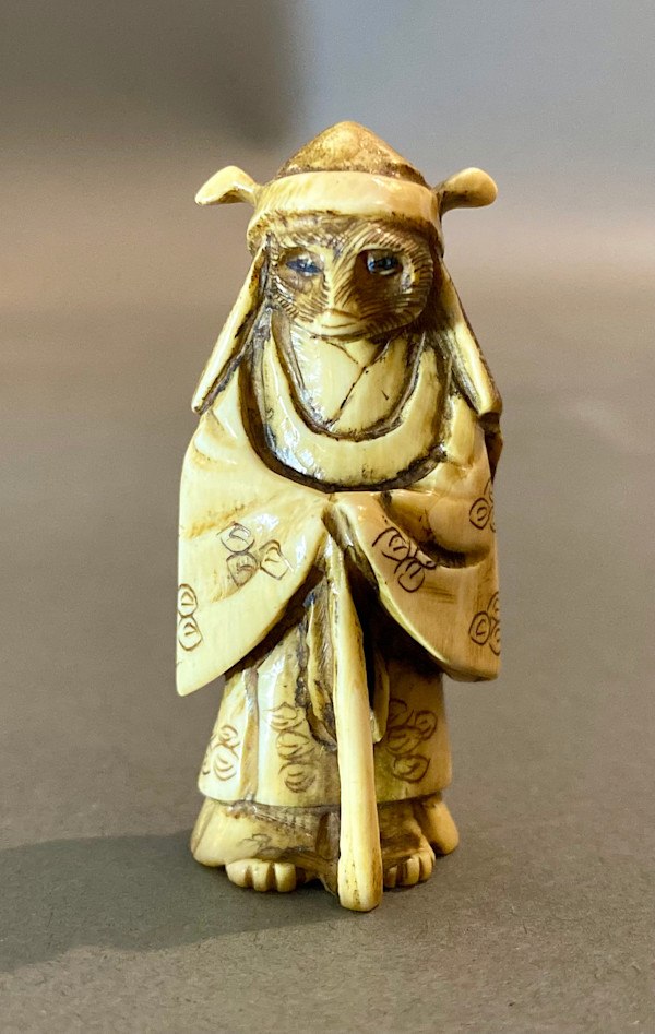 Netsuke - Raccoon dog dressed as a priest