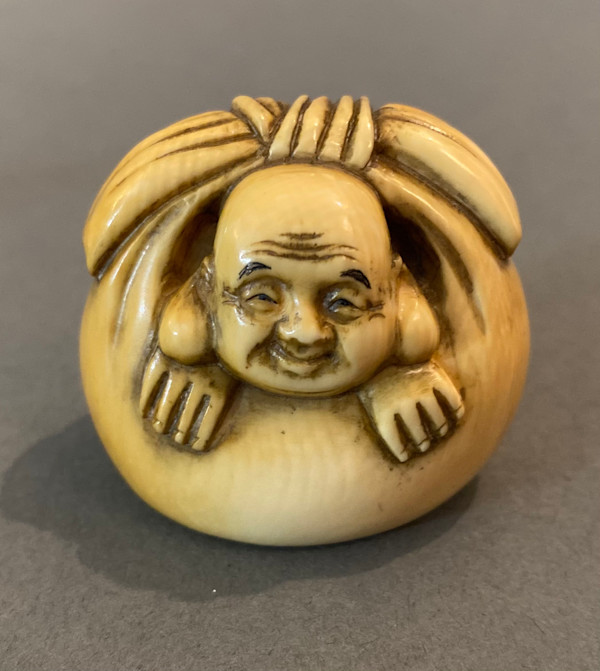 Netsuke - Hotei in his treasure bag by Masayuki