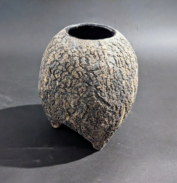 Globular ceramic ikebana vase on three feet