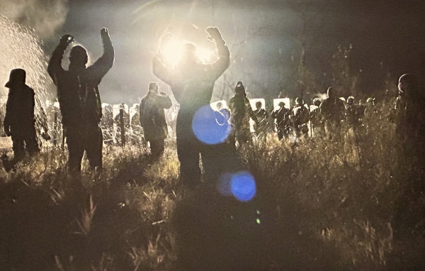 Water protectors praying at police line, Nov 20, 2016 by Jon Willis