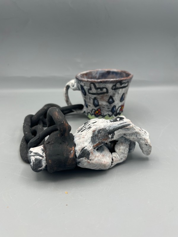 Cup Chained to a Hand by Caleb Paul