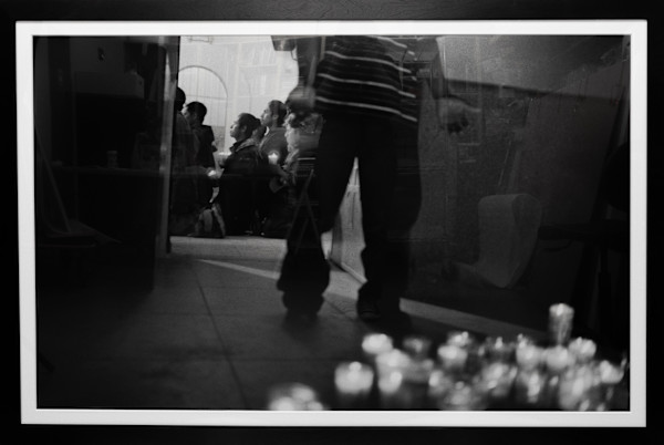 Young men and boys from southern Mêxico light votive candles and pray for a safe crossing before leaving the Sonoran town of Altar by Julián Cardona