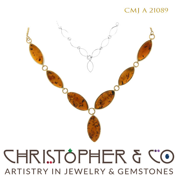 CMJ A 21089 Gold necklace by Christopher M. Jupp set with seven Amber cabachons.